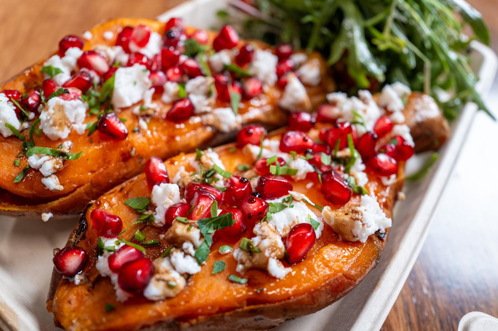 Sweet potatoes topped with cheese and pomegranate for Thanksgiving appetizers