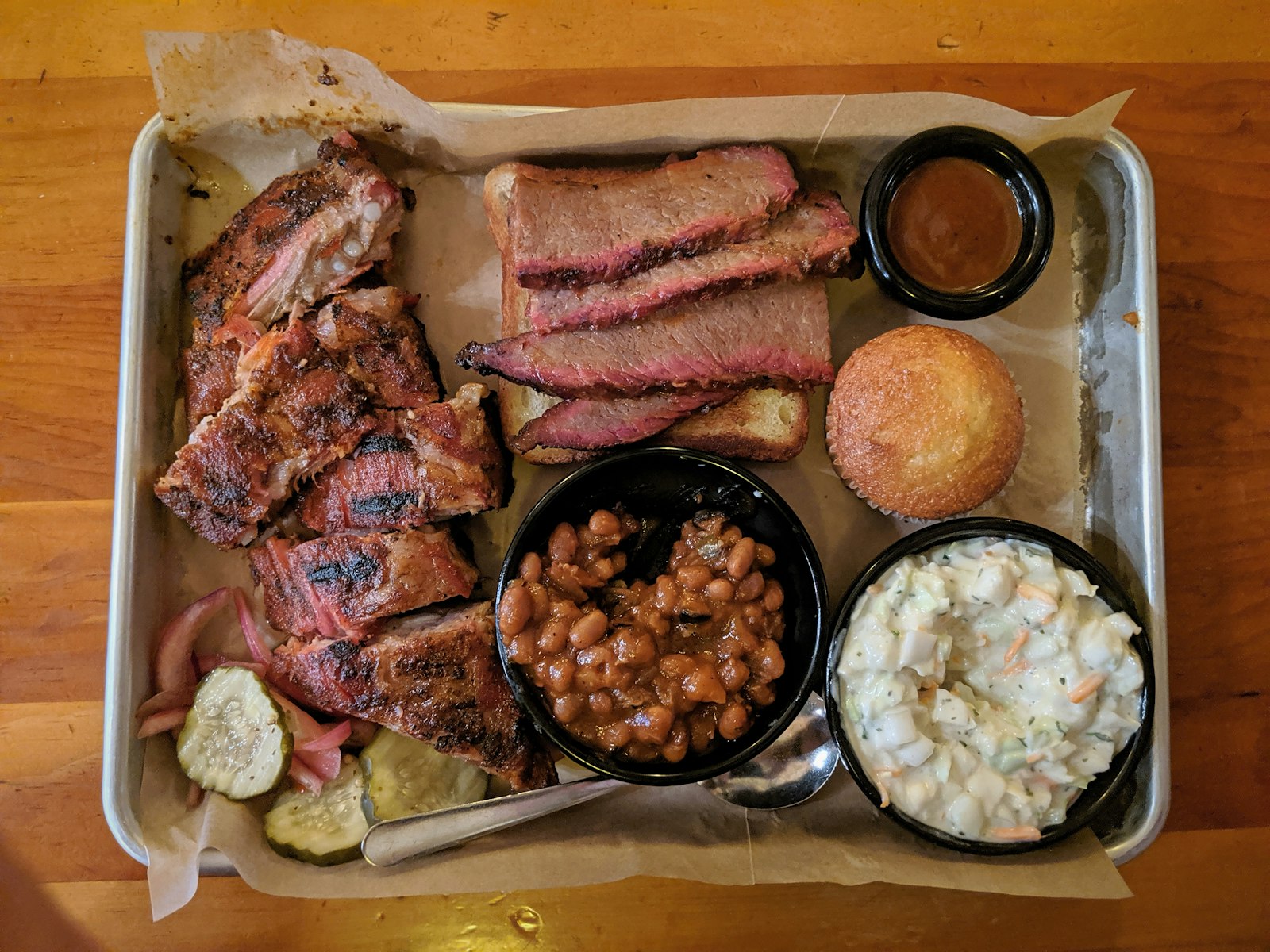 Barbecue tray with brisket and a cup of baked beans