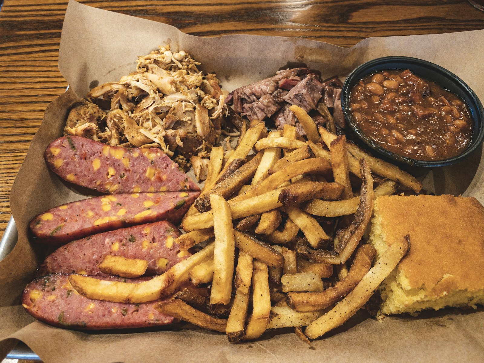 A barbecue plate with beans, meat and cornbread