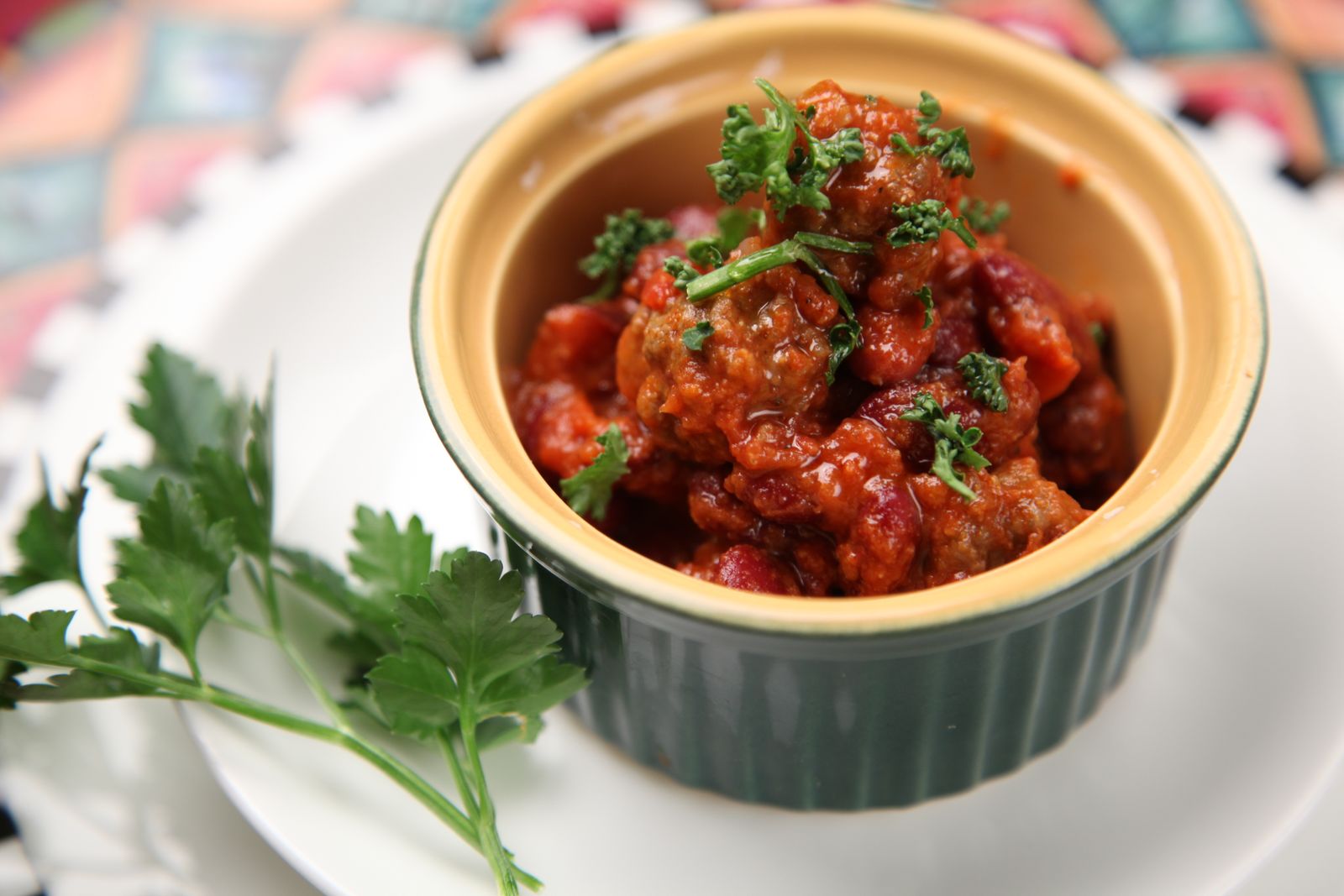A small crock of a saucy potluck side with parsley
