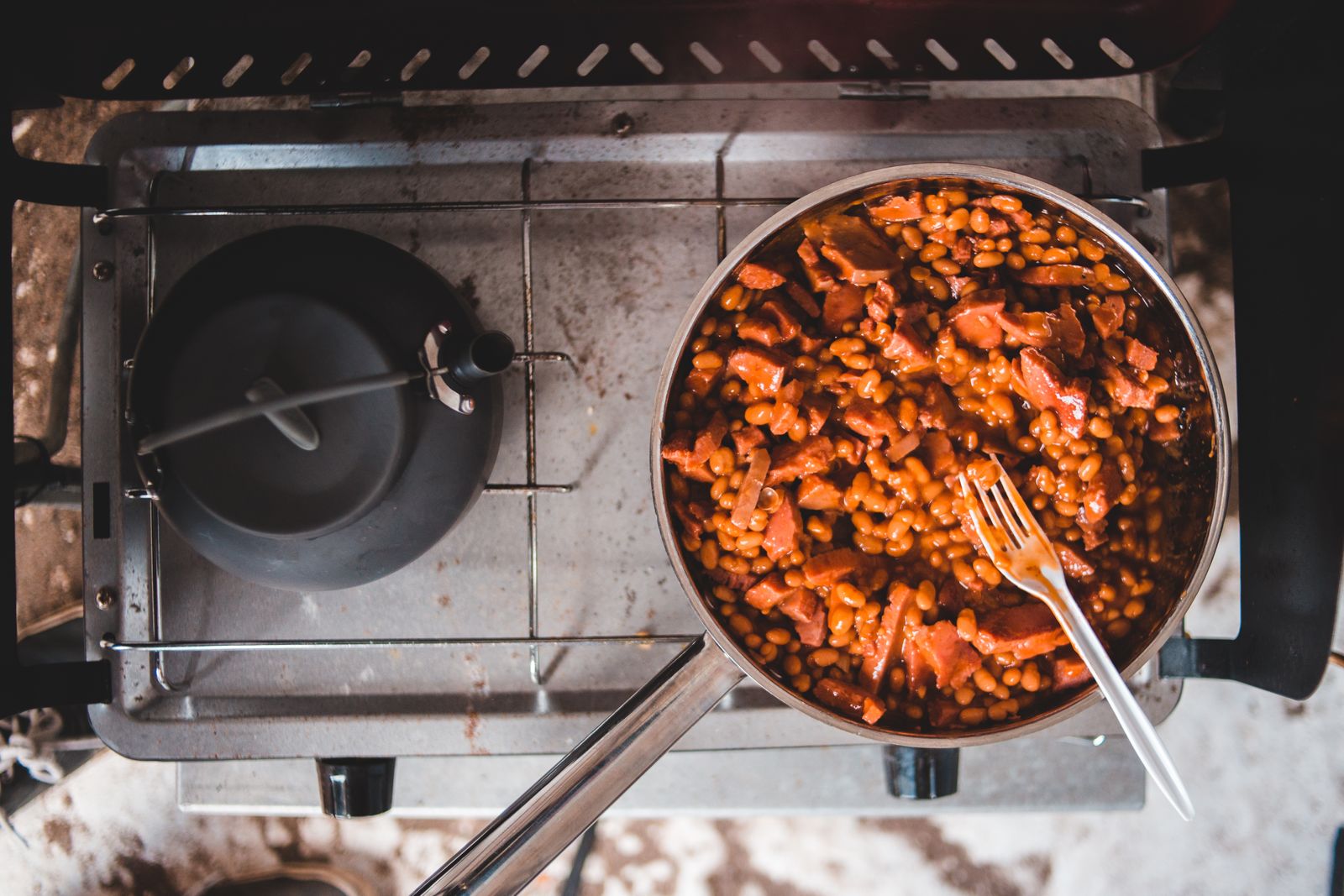 A skillet of smoked sausage in a sweet sauce