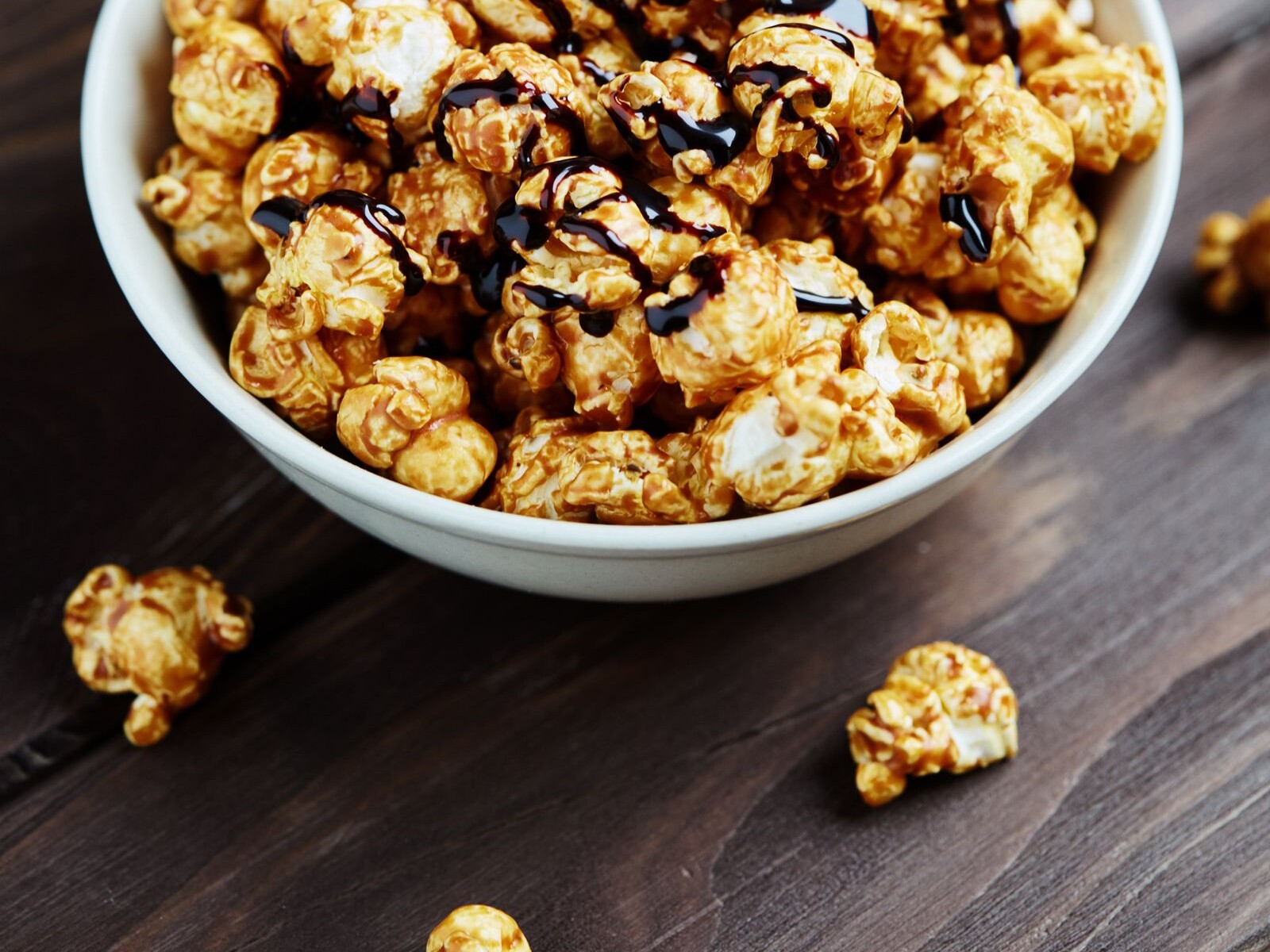 A bowl of popcorn drizzled with chocolate