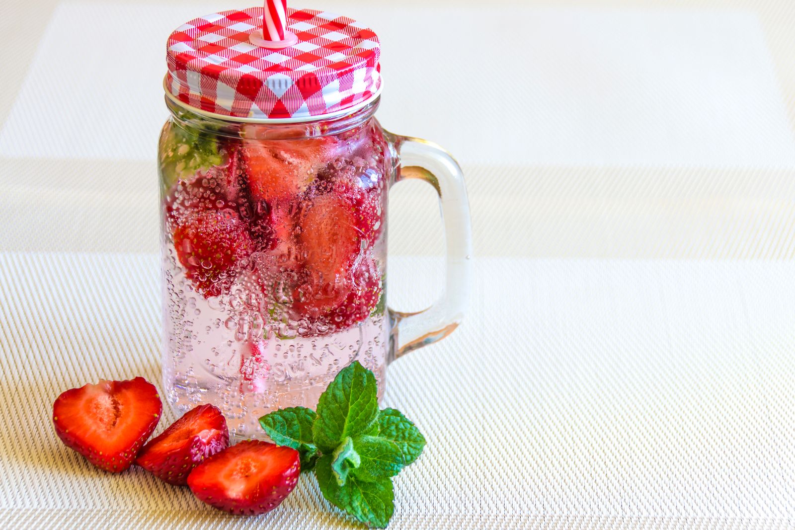 Strawberry and mint sparkling water in a mason jar