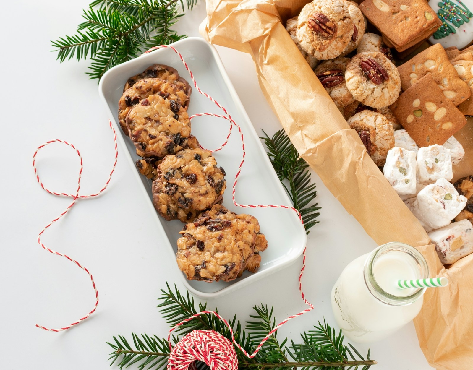 Chocolate chip cookies in a white dish tied with red and white baker's twine