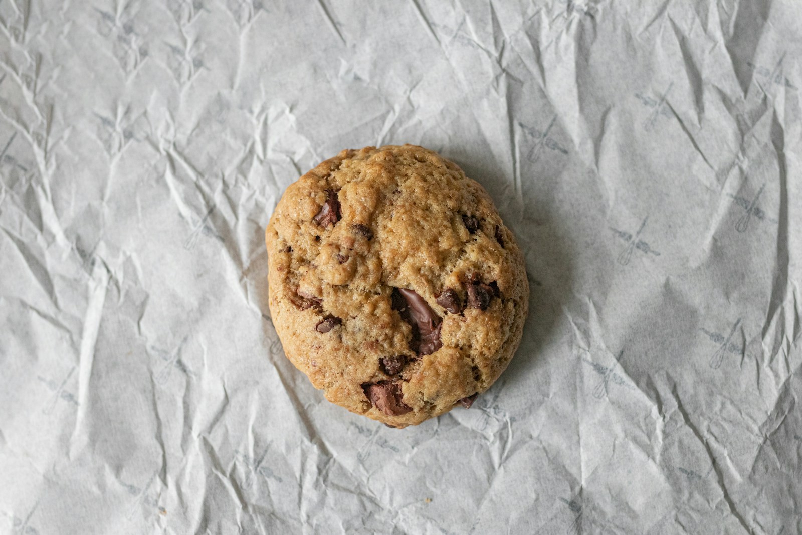 Almond butter chocolate chunk cookie on crinkled paper