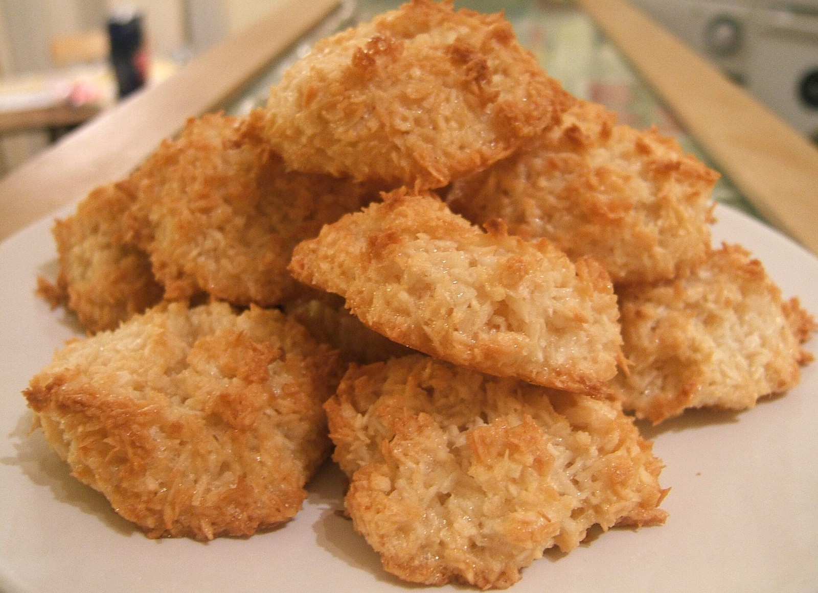 Golden coconut macaroons piled on a plate