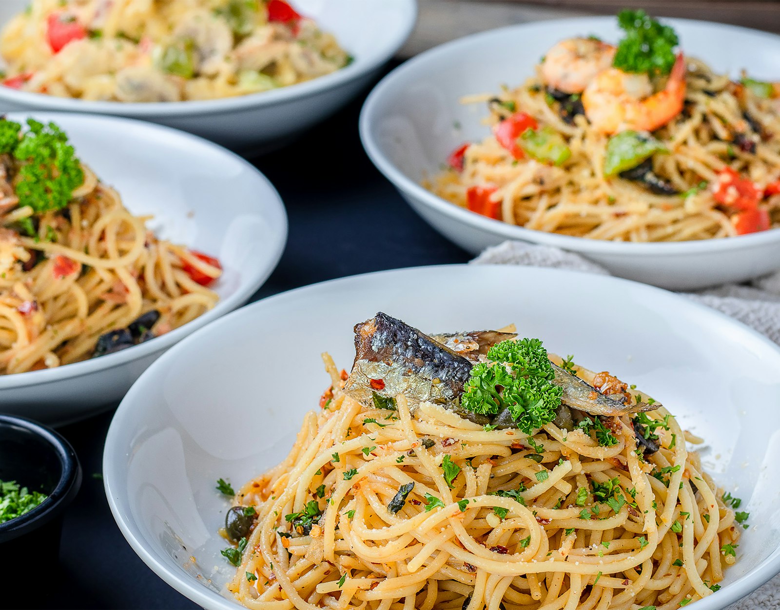Spaghetti topped with sardines and herbs