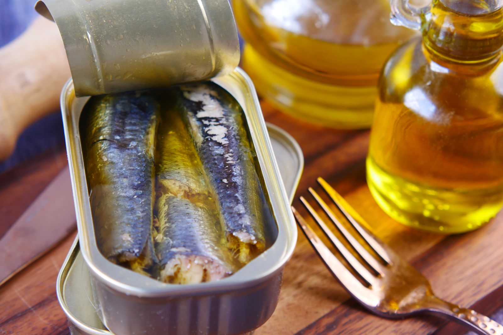 An open tin of sardines in olive oil