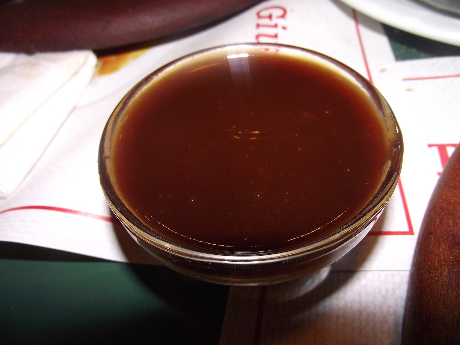 Thick dark red Kansas City homemade BBQ sauce in a glass bowl