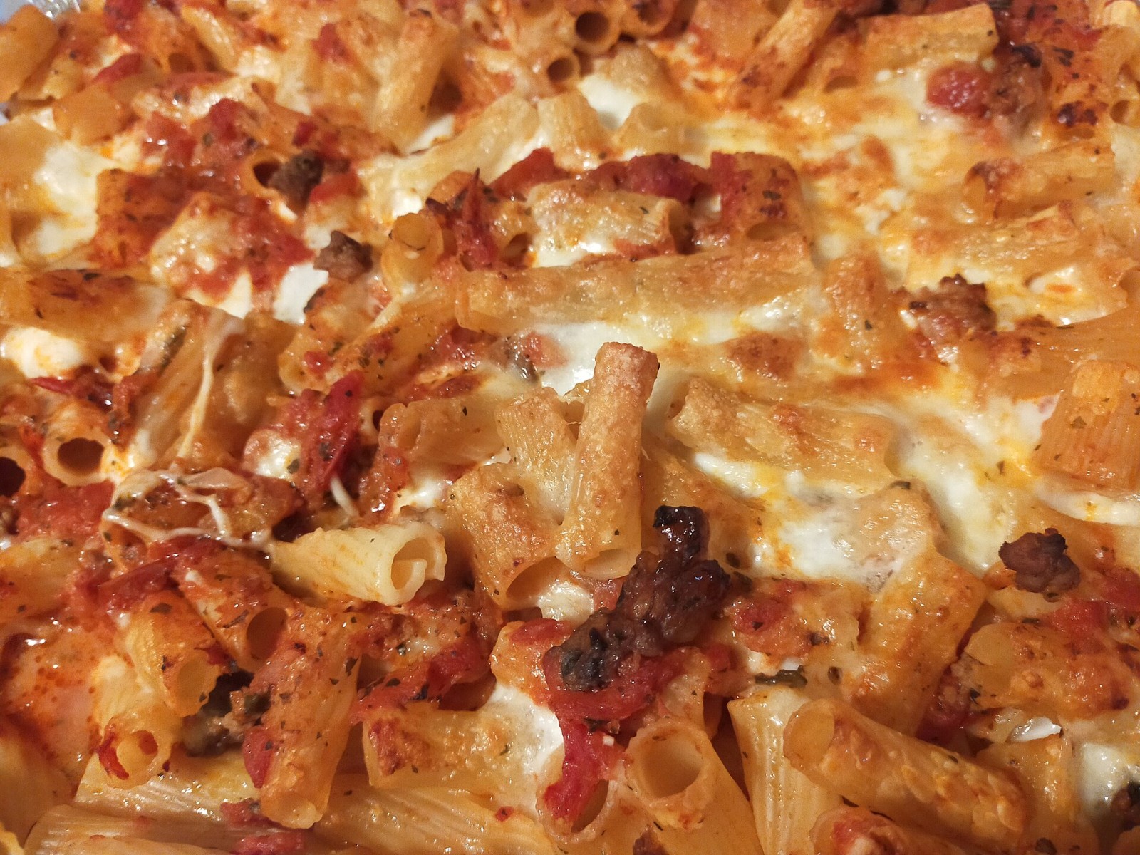 Neapolitan Italian baked pasta with ragu and melted cheese in a dish