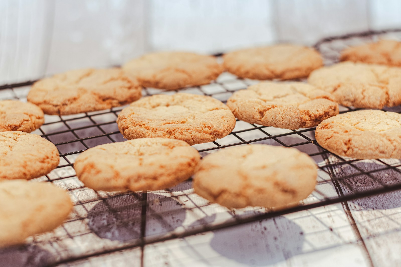 Golden sugar cookies cooling on a wire rack