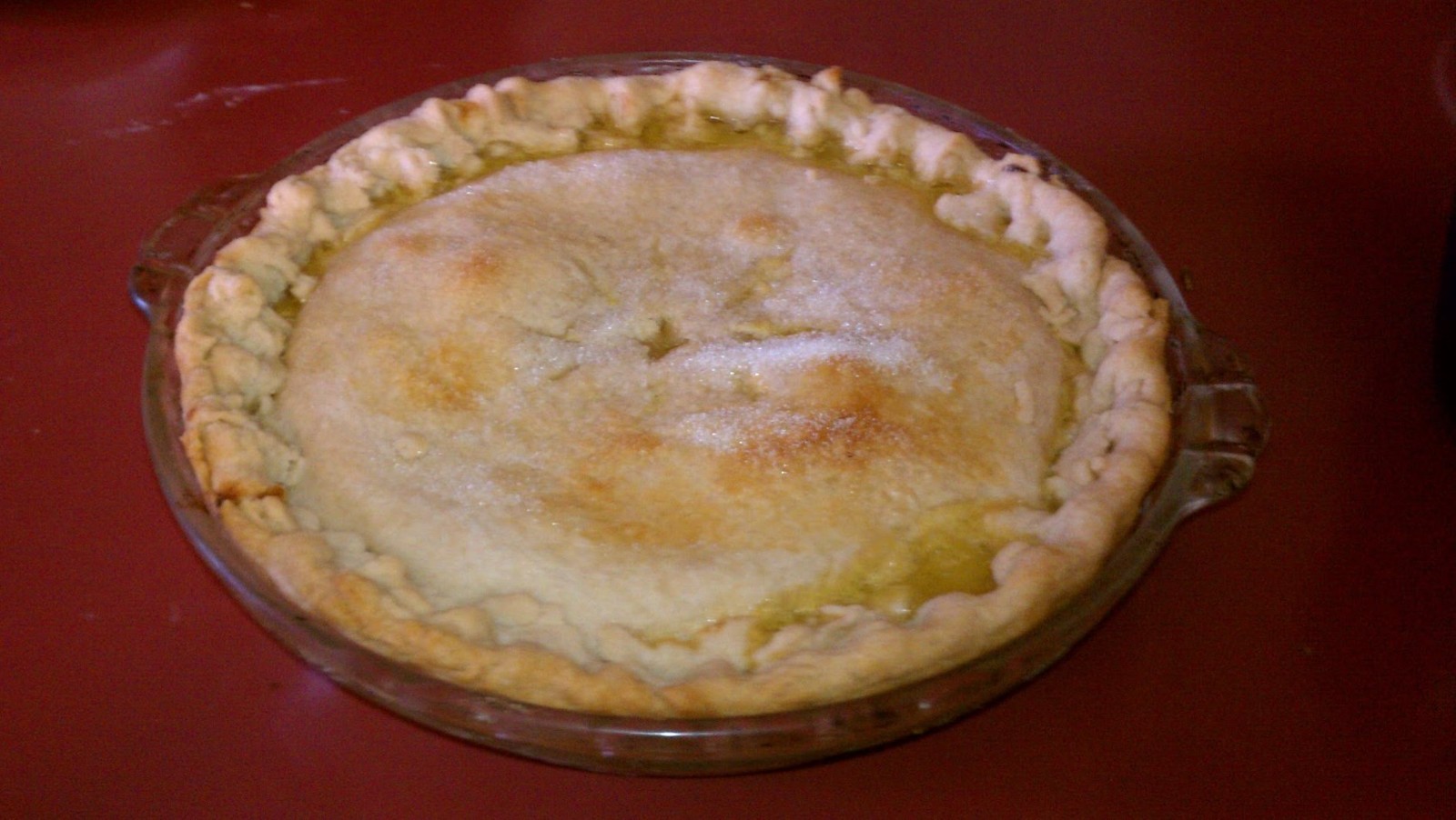 Double crust Shaker pie with a golden top in a glass pie plate