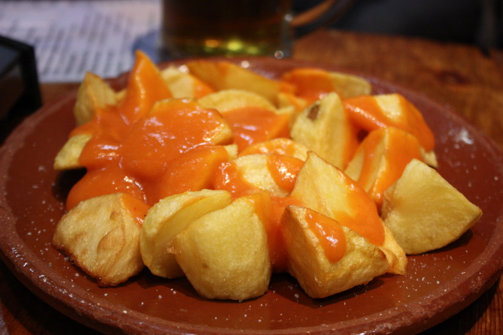 Crispy smashed potatoes with spicy bravas sauce