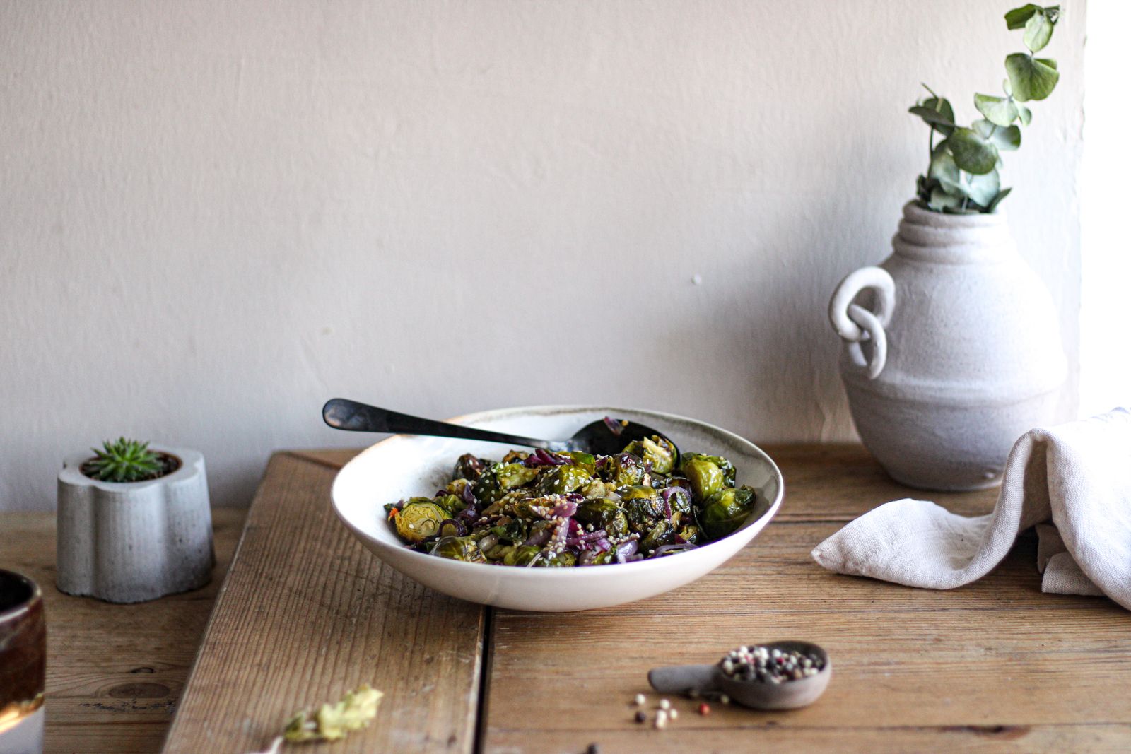 A bowl of roasted Brussels sprouts with seeds