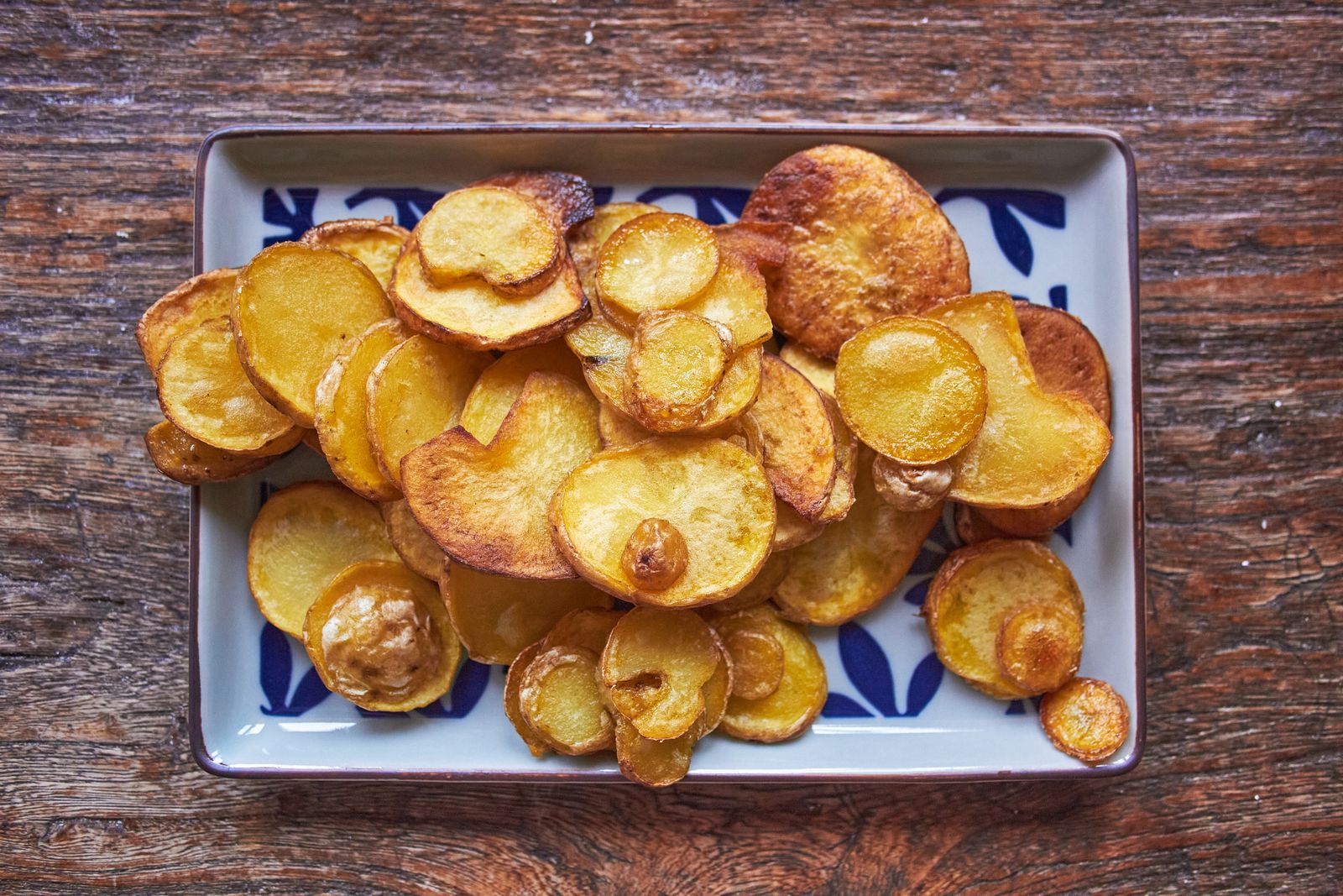 Crispy golden potato coins on a tray