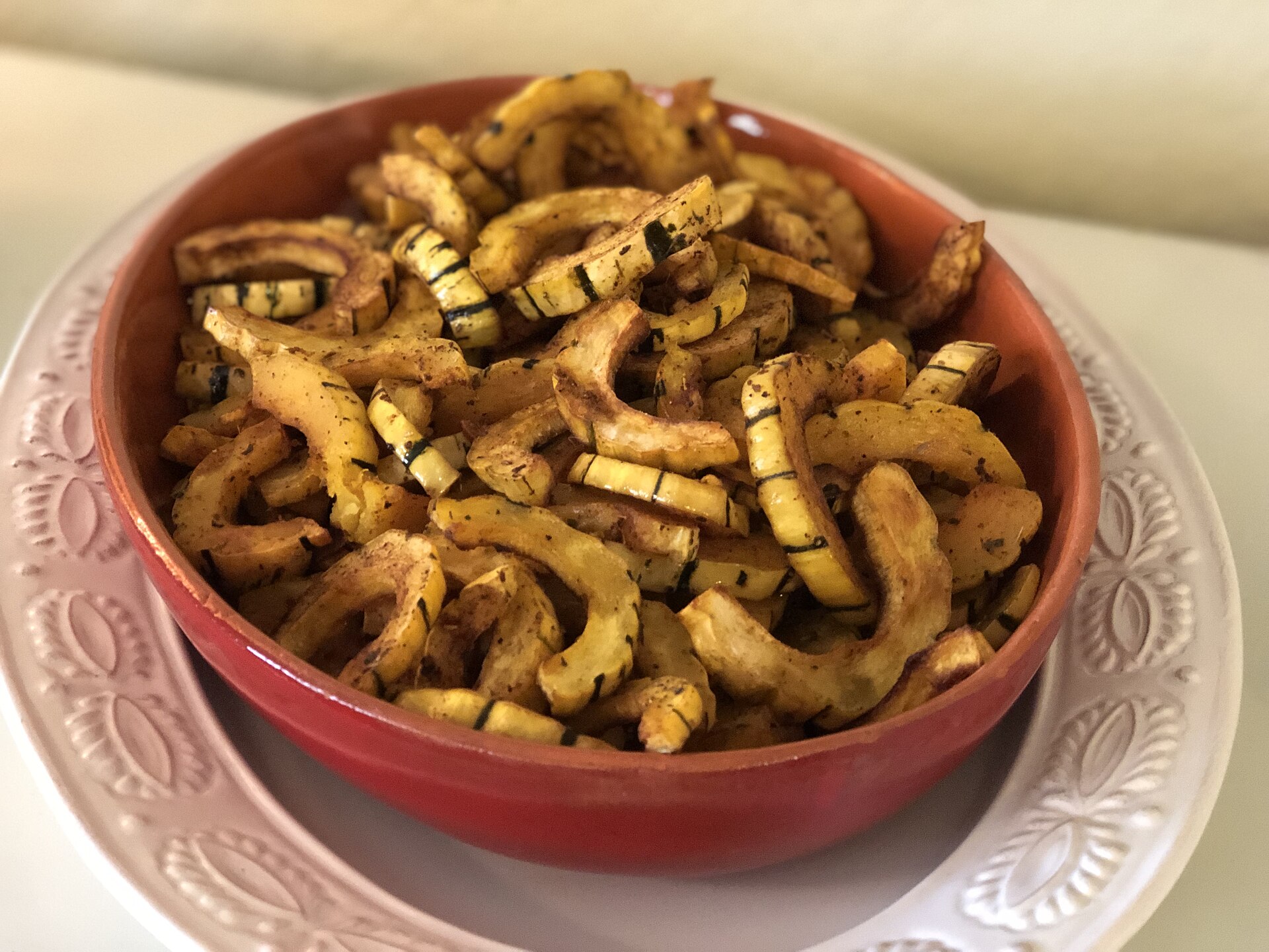A bowl of roasted delicata squash rings
