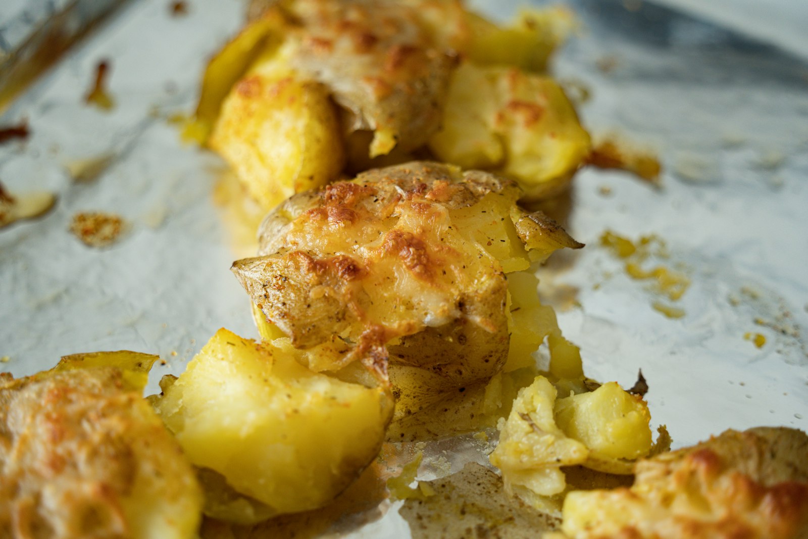 Crispy smashed potatoes with melted cheese