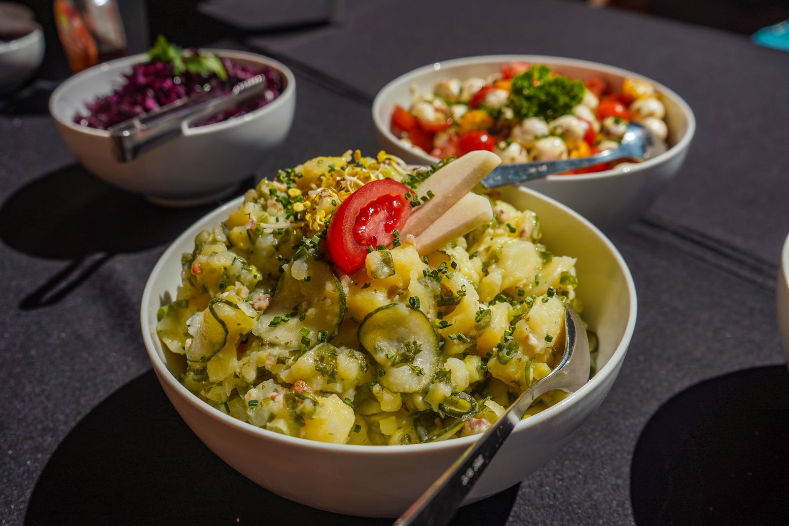 A bowl of potato salad with herbs