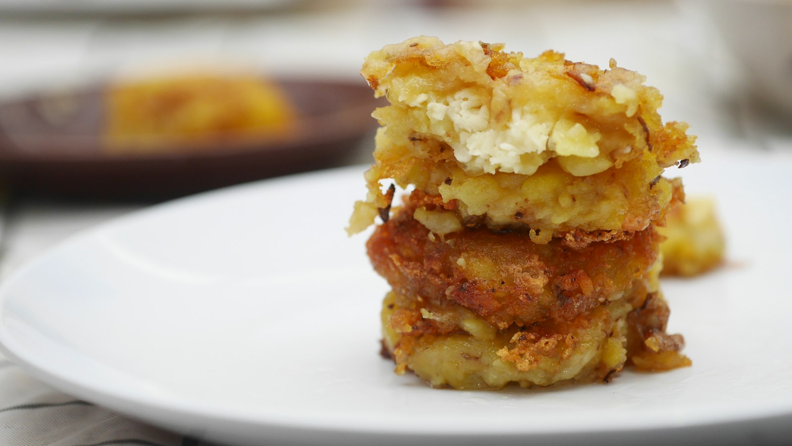 A crispy layered potato stack on a plate
