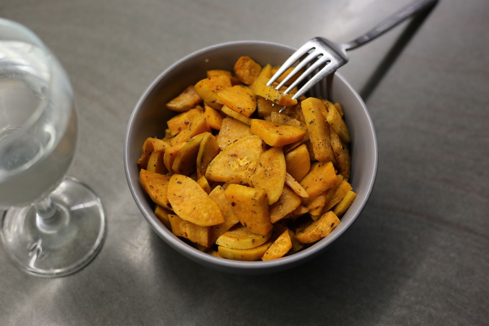 A bowl of crispy roasted sweet potato pieces
