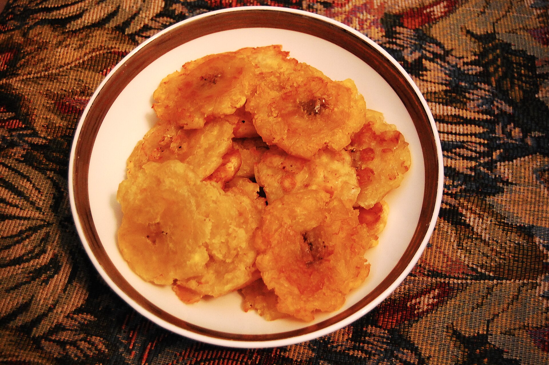A plate of crispy tostones, smashed fried plantains