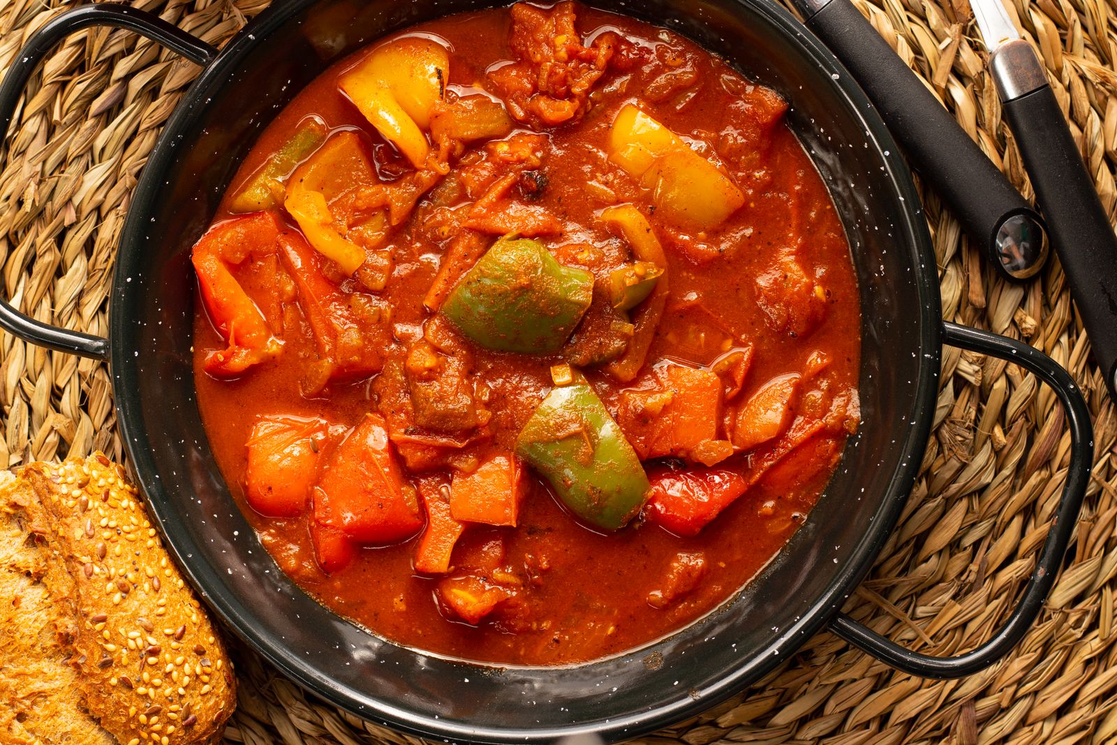 Chunky bell pepper and beef stew in a black pot