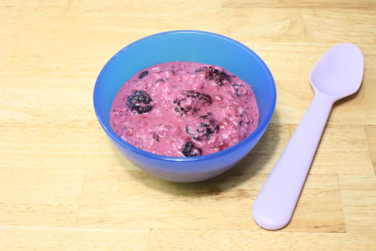 Overnight oats with berries in a blue bowl
