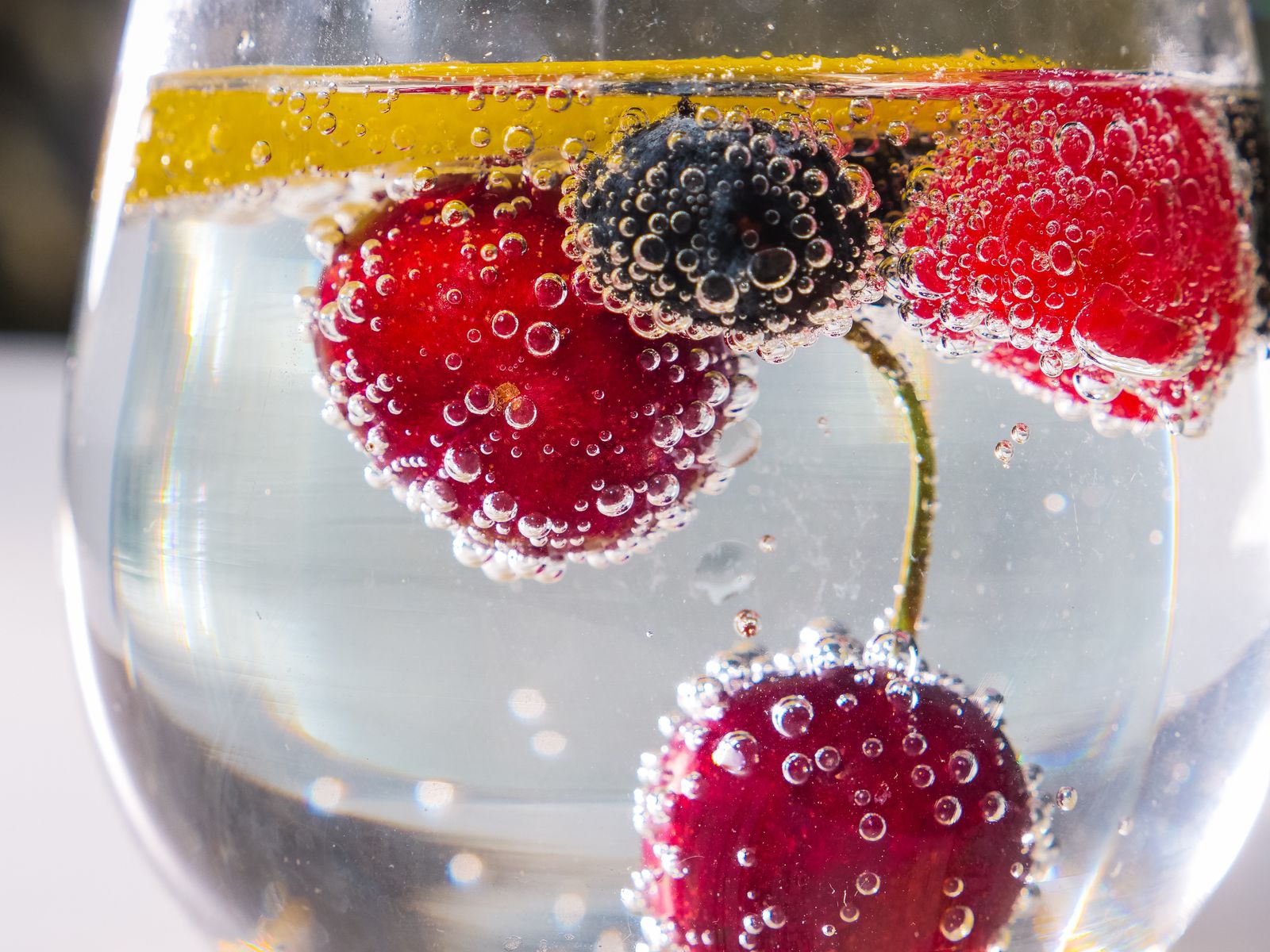 Sparkling water with berries and lemon, a soda swap with no added sugar