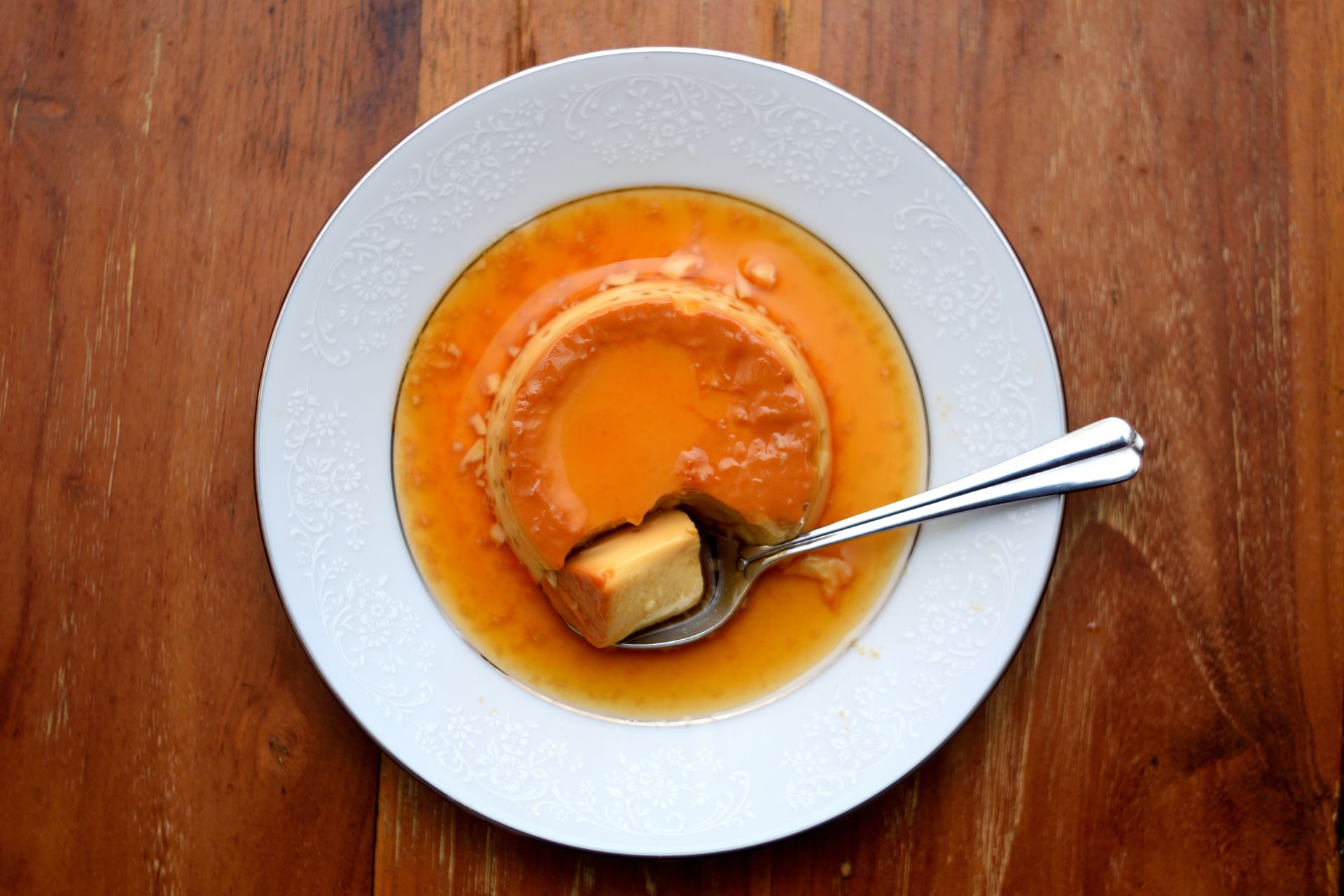 Baked custard in a bowl with a spoon