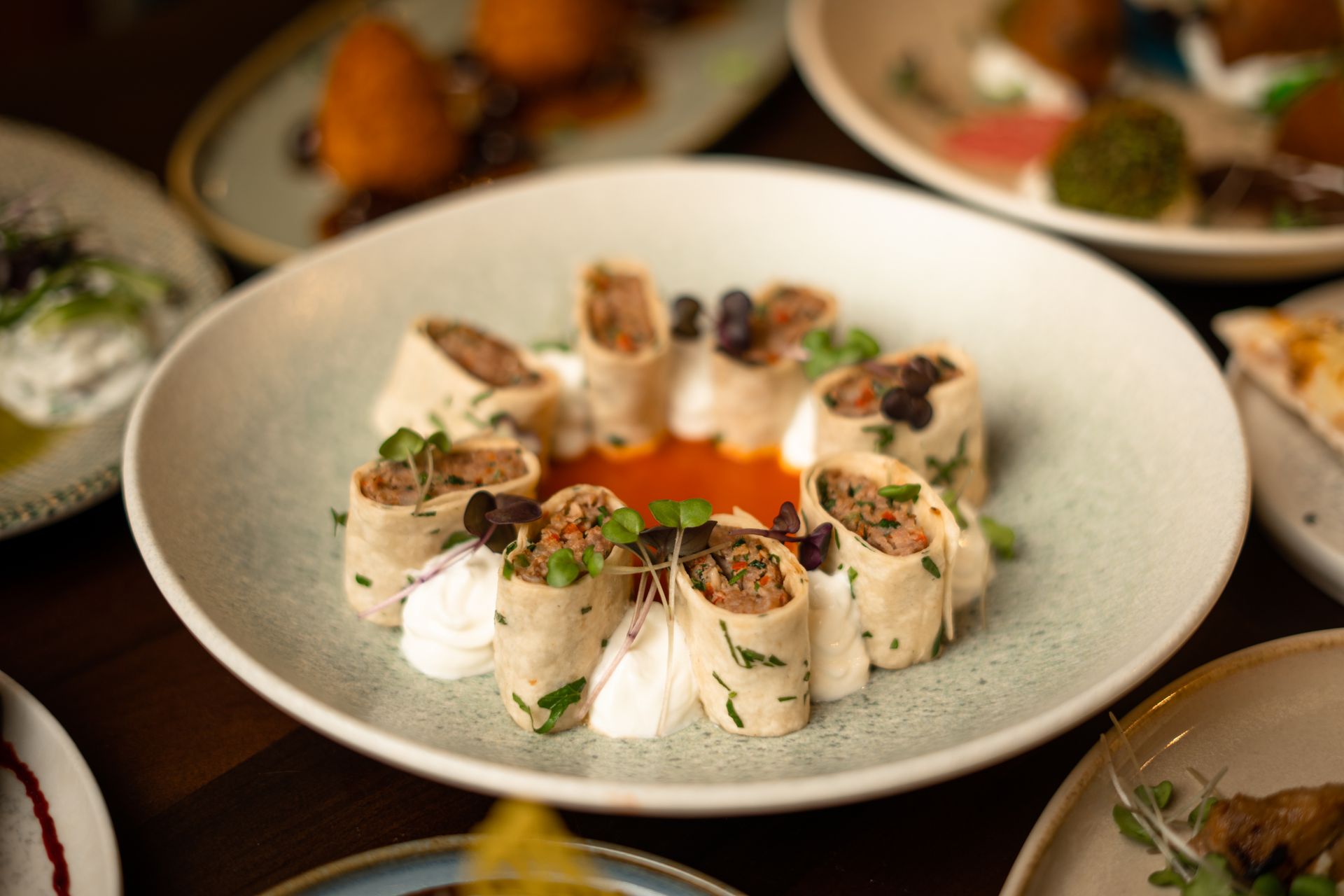 Rolled tortilla appetizers on a white plate