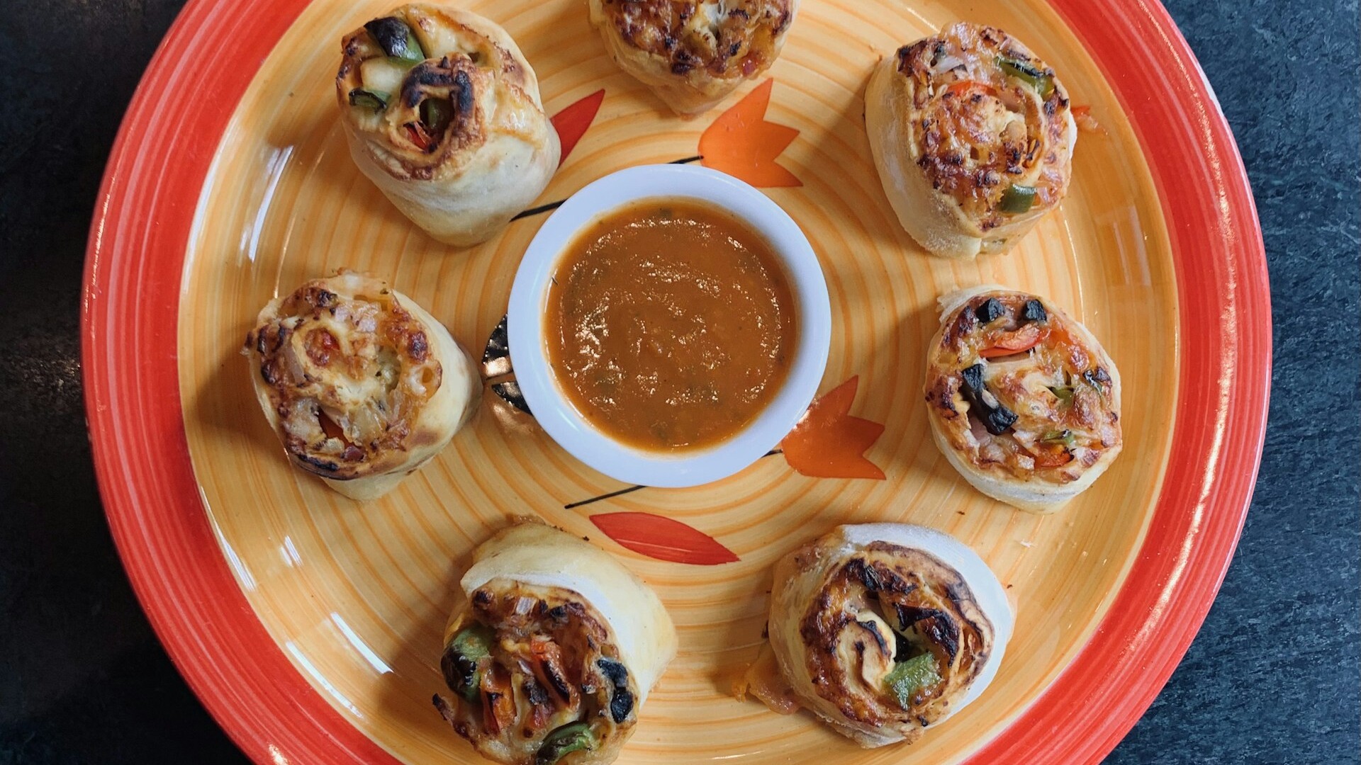 Christmas pinwheels: tortilla pinwheels arranged around a bowl of dip