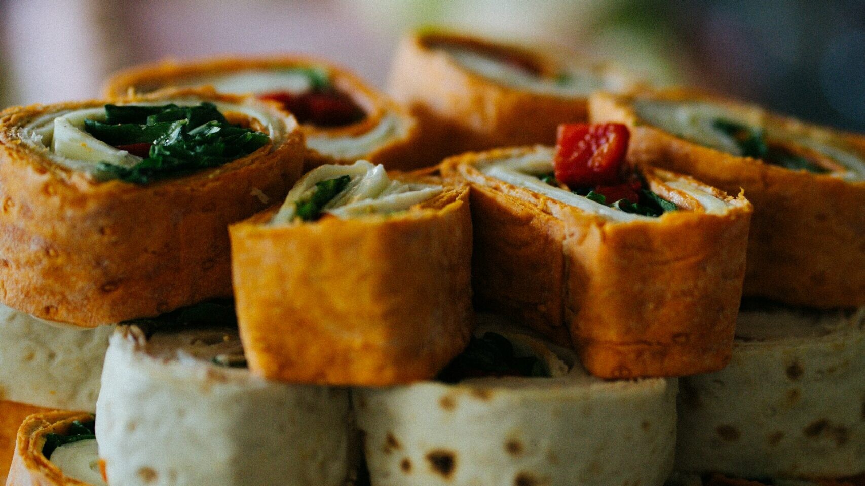 Christmas pinwheels: turkey and spinach tortilla rolls sliced on a board