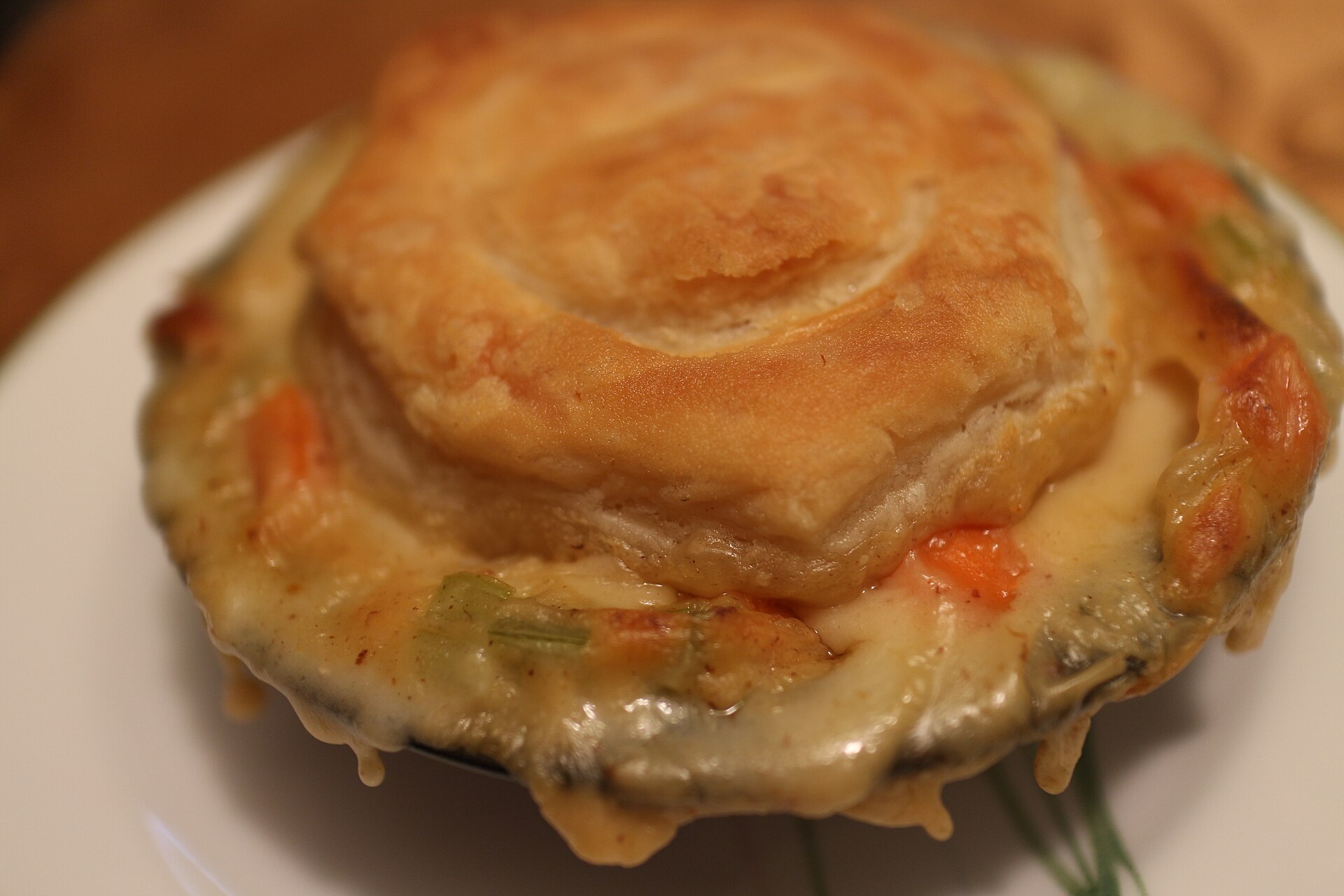 A chicken pot pie with a flaky golden crust