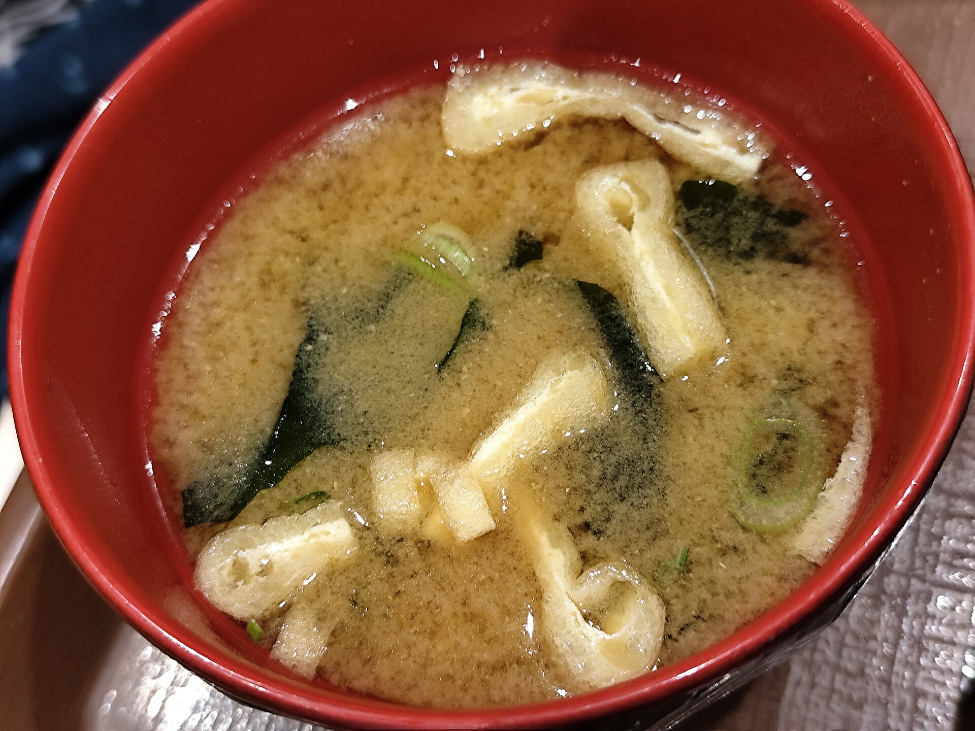 Japanese breakfast miso soup in a red bowl