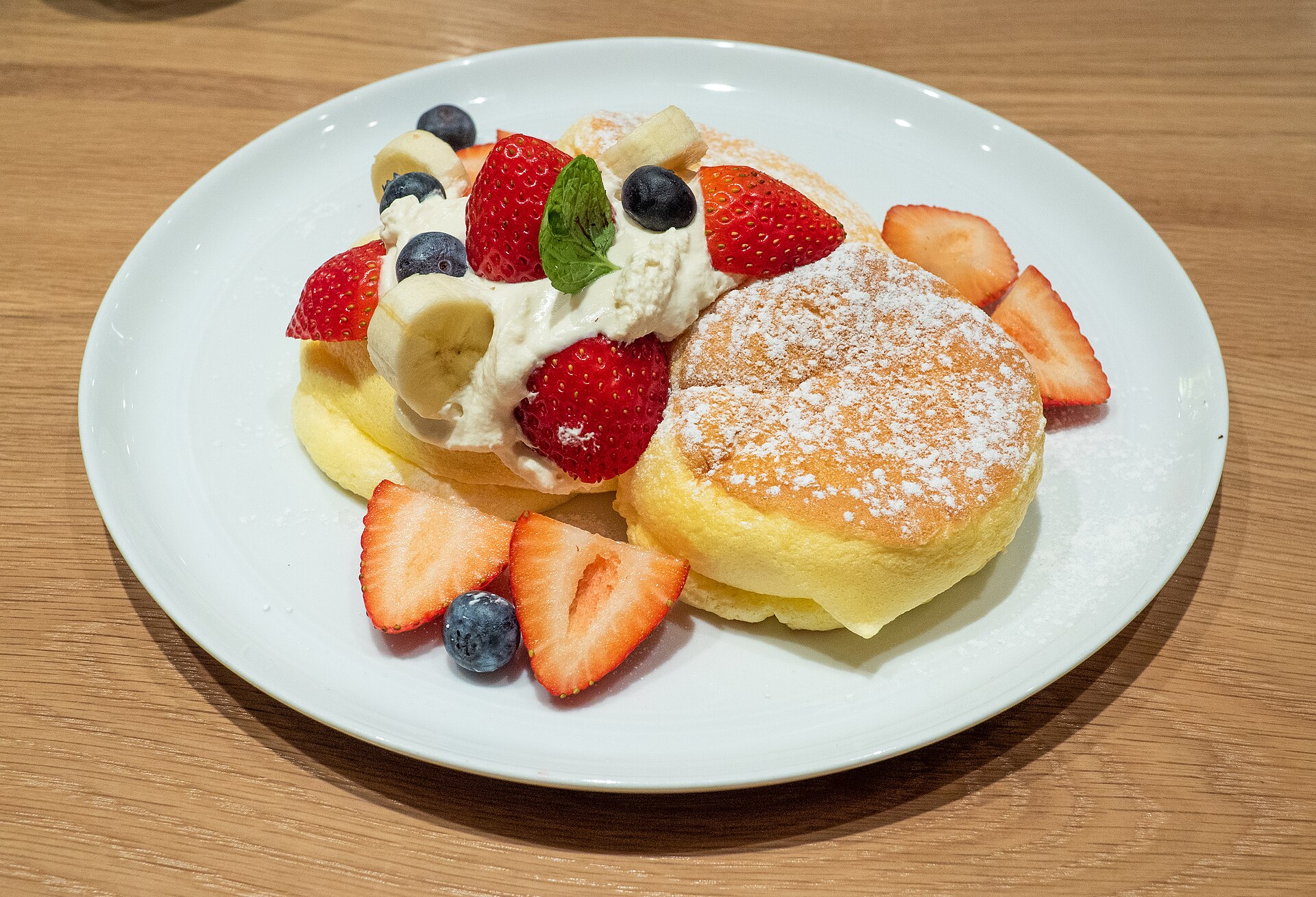 Japanese breakfast souffle pancakes with strawberries and cream