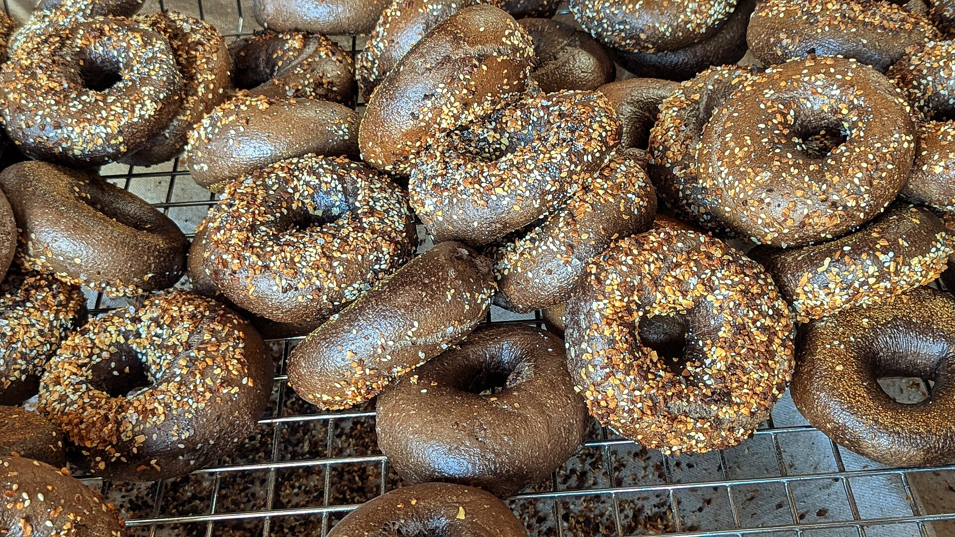 Seeded bagels cooling on a wire rack