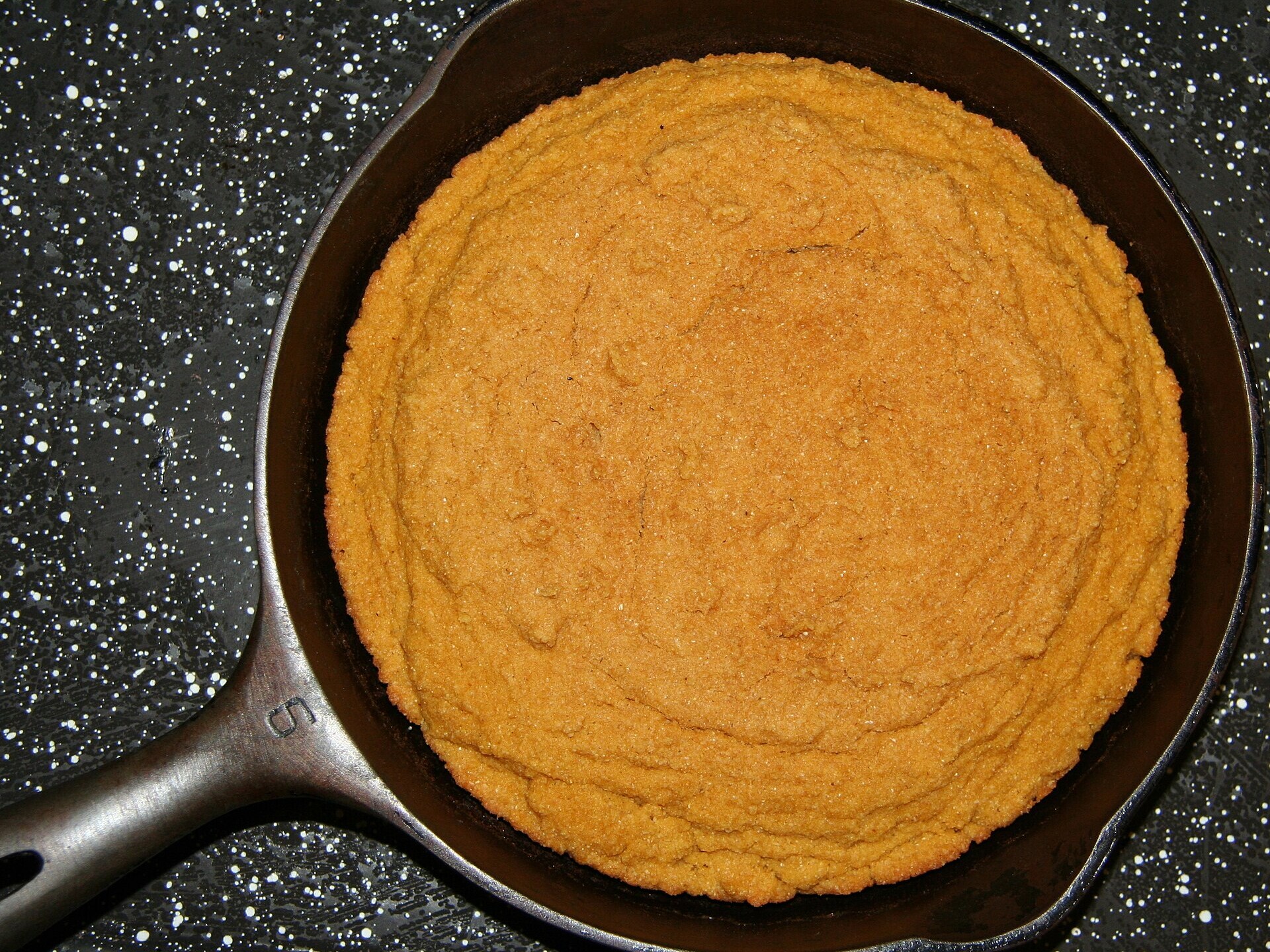 Golden keto cornbread in a cast iron skillet