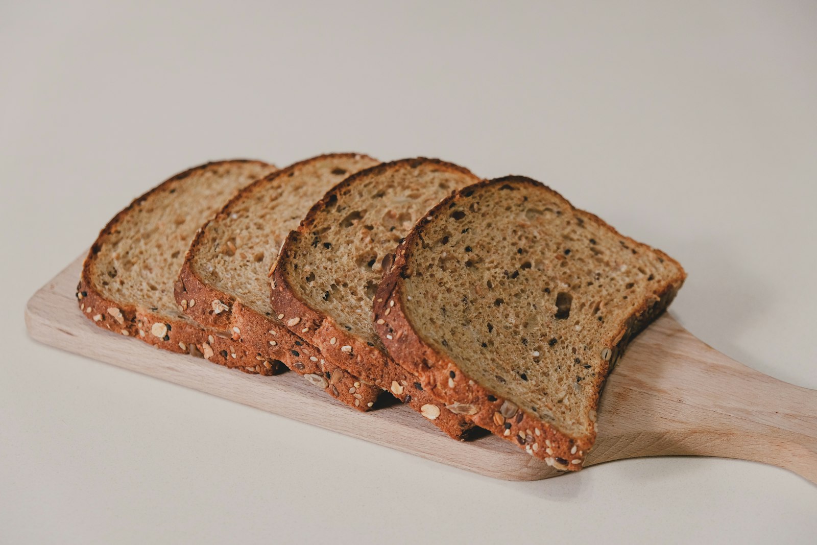 Seeded keto bread sliced on a wooden board