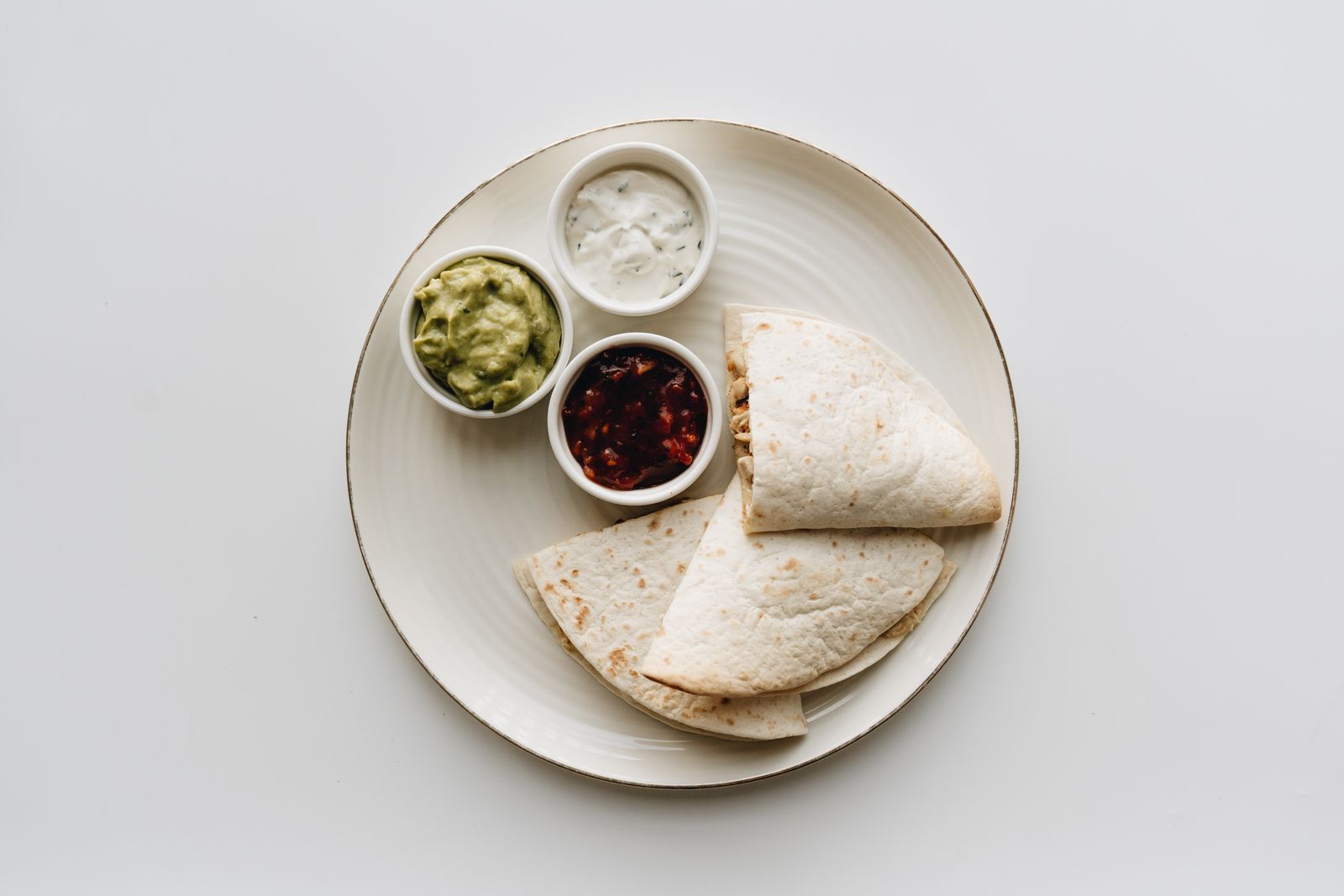 Folded tortillas with guacamole and salsa