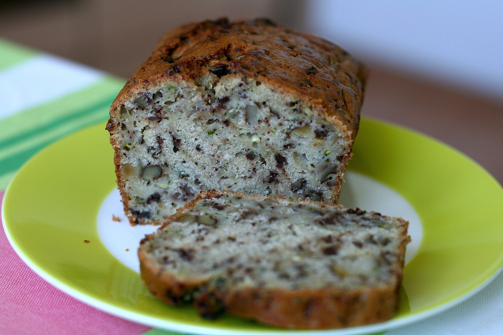 Sliced zucchini bread on a green plate