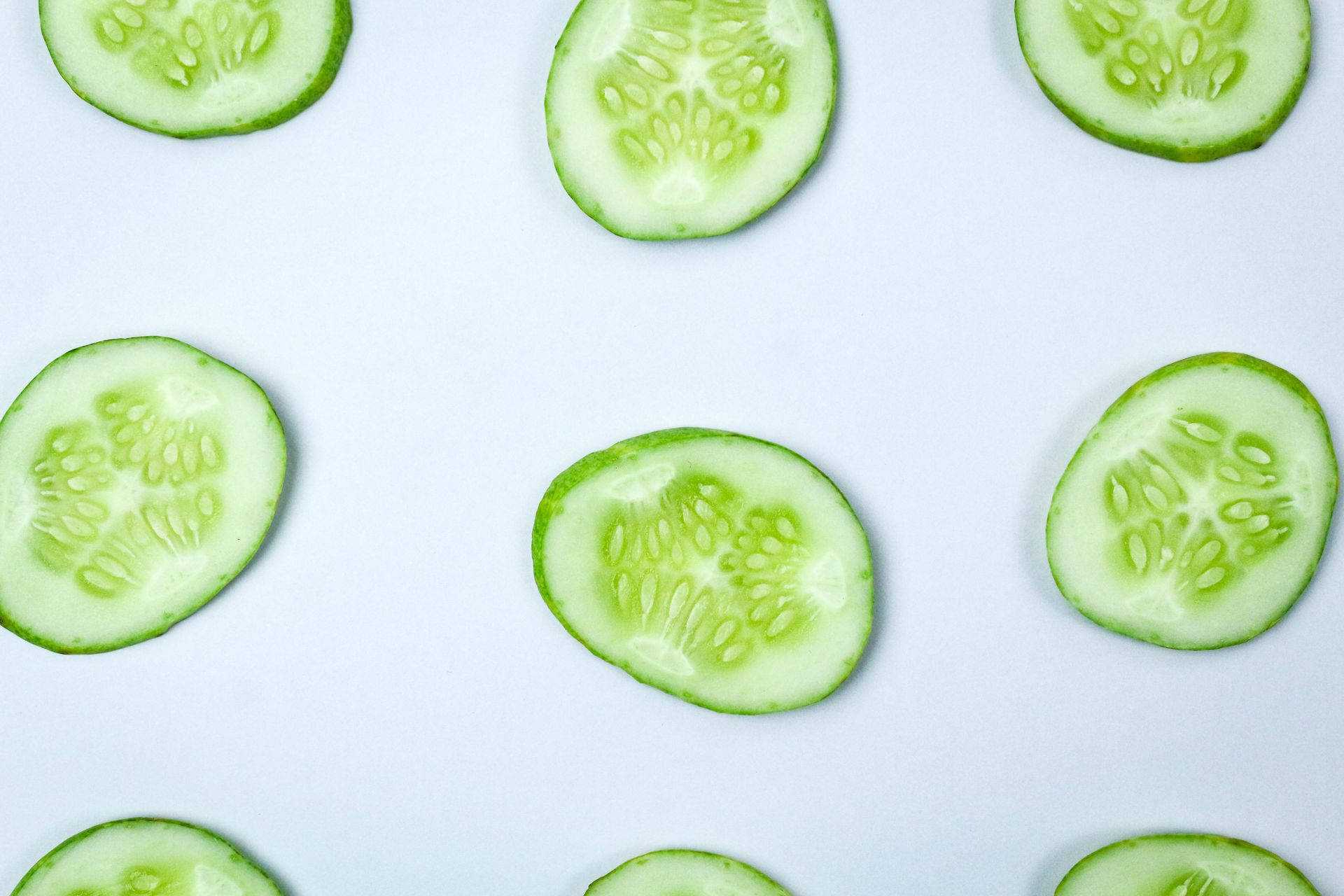 Fun food for kids: round cucumber slices on a white plate
