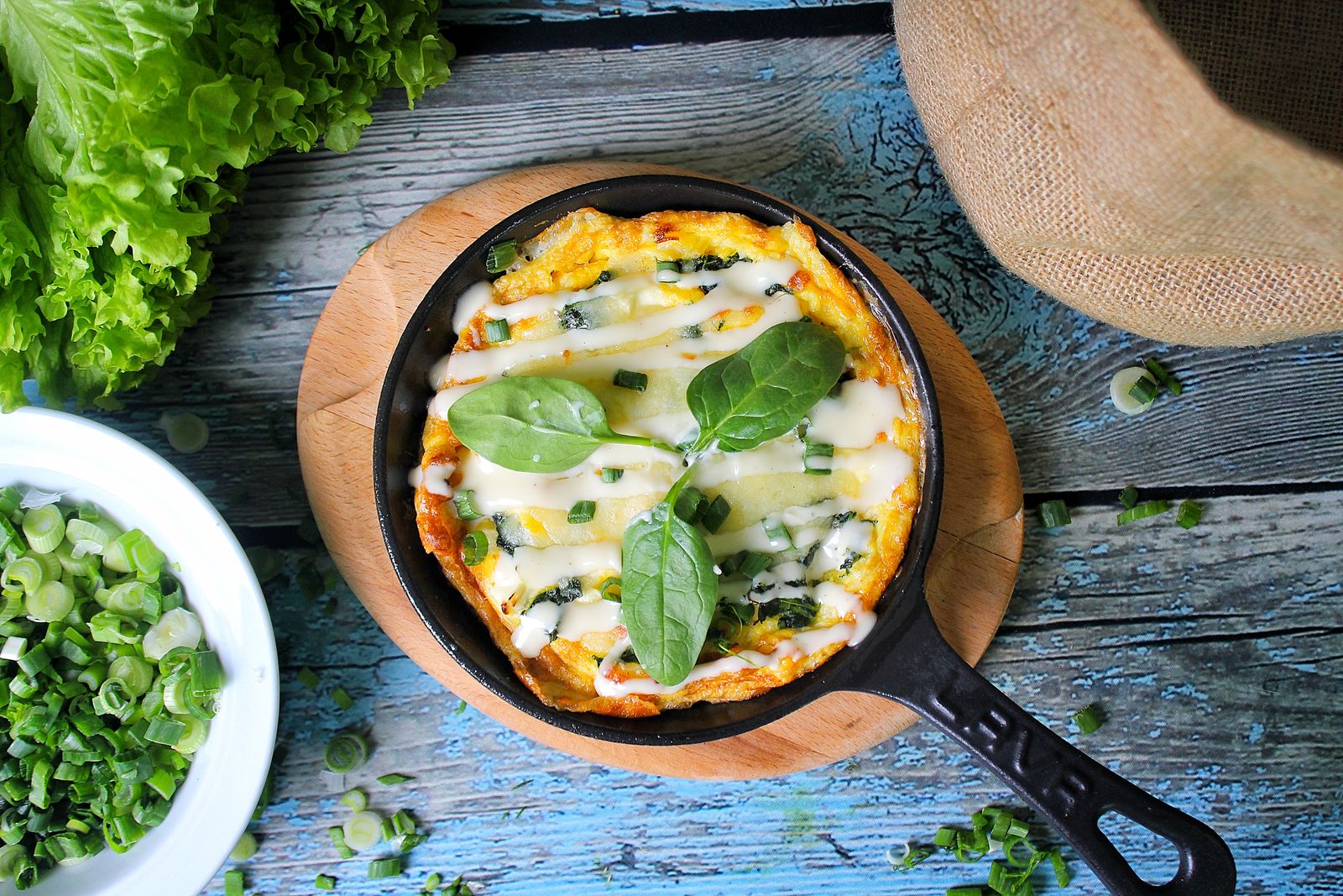Oats and eggs omelet with cheese and spinach in a skillet