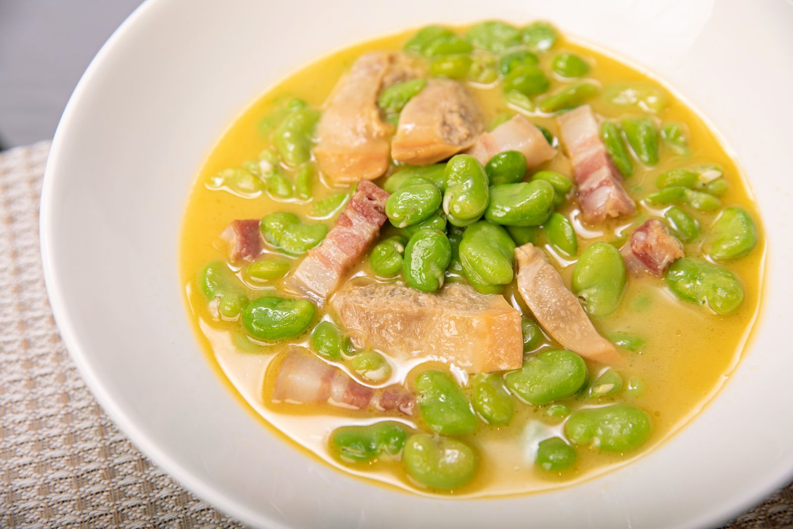 Butter bean and ham soup in a white bowl