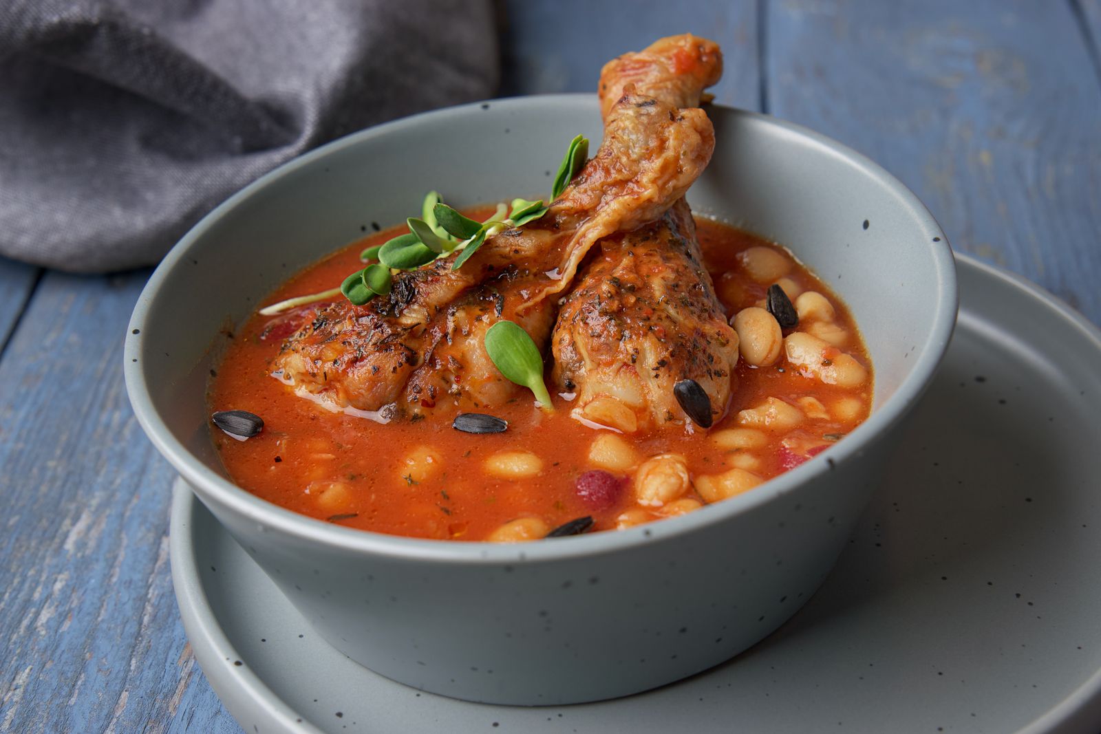 Chicken and white bean soup in a blue bowl