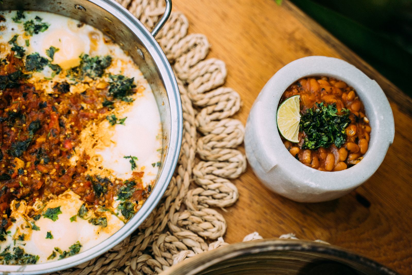 A bowl of seasoned beans with lime and herbs
