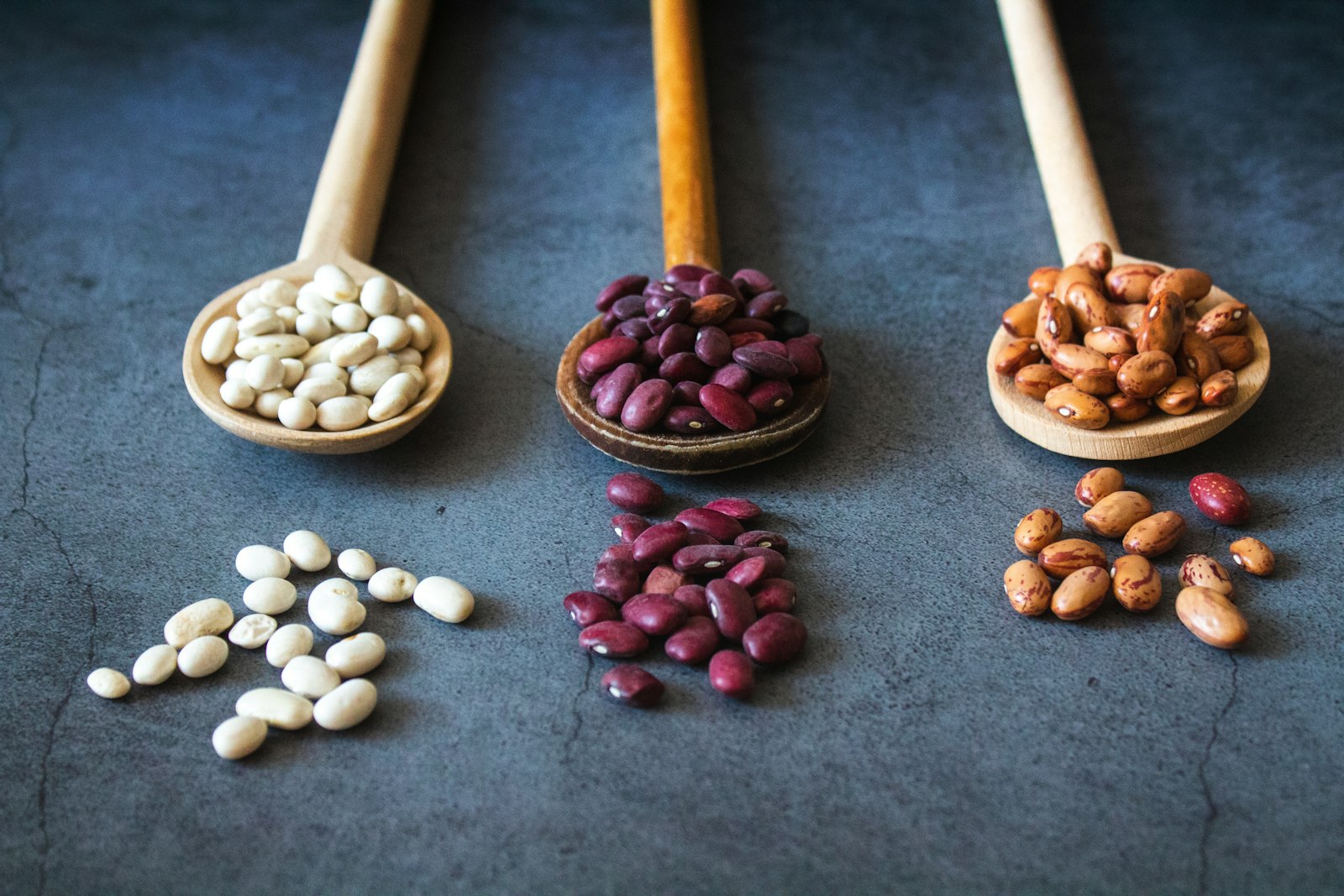 Dried beans in wooden spoons ready for soaking