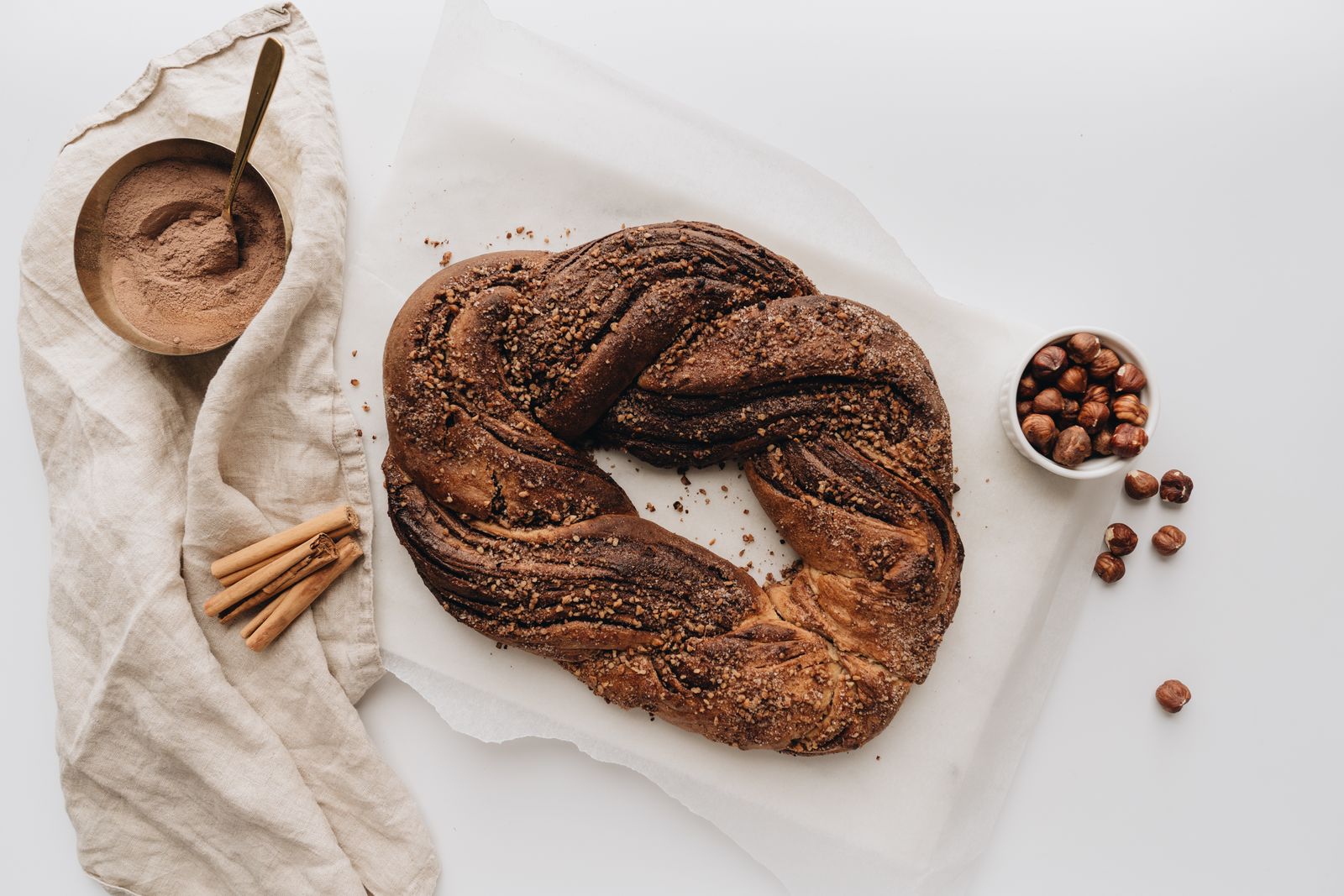 A twisted cinnamon sugar pastry ring on parchment