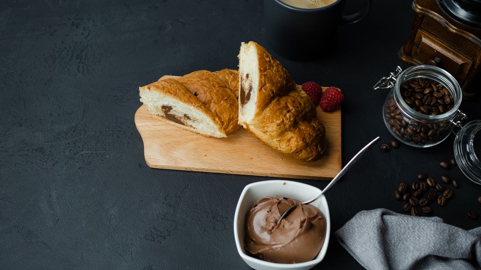 Chocolate filled crescent rolls cut open on a board