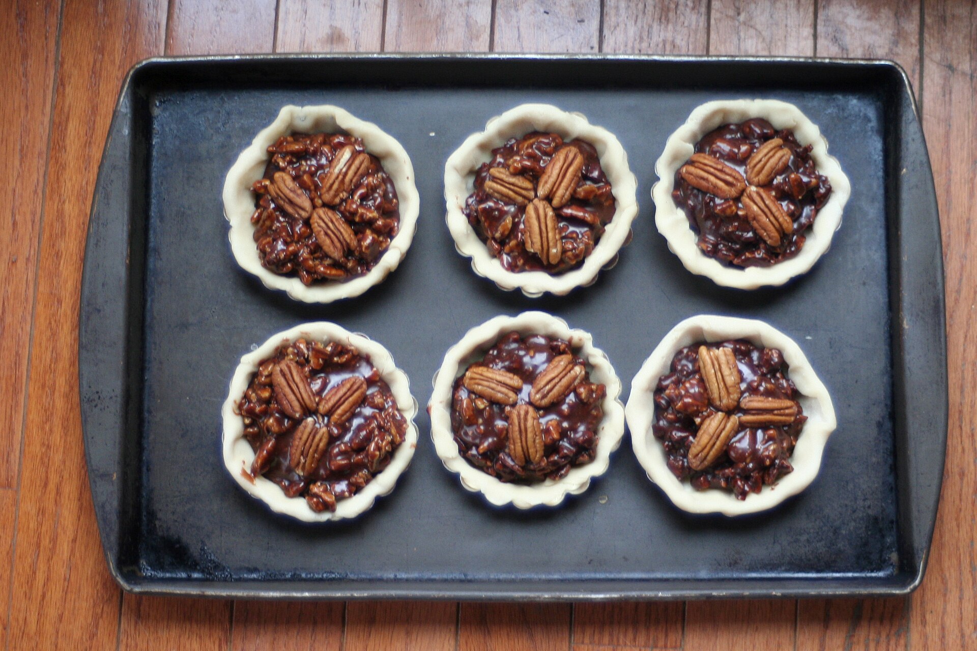 Mini pecan pie bites on a baking sheet