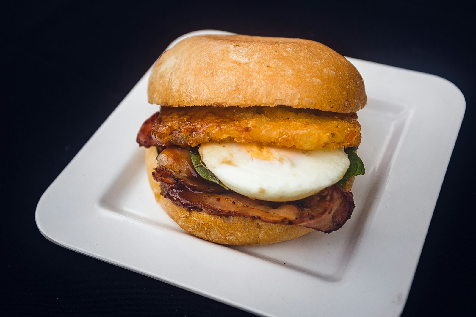 A breakfast burger topped with a fried egg